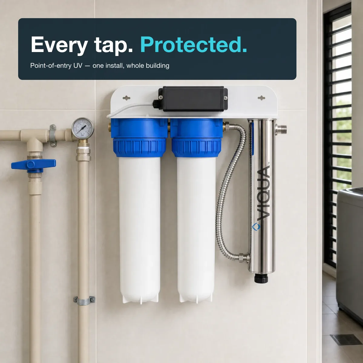 Viqua VH410-F22 UV system wall-mounted in a modern ASEAN residential utility room with PVC plumbing and LED lighting.